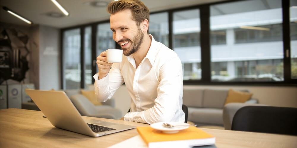 Man smiling with laptop